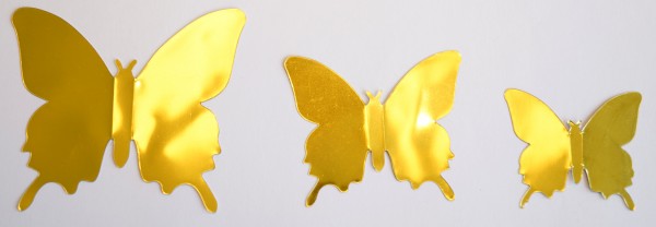 Glänzende Schmetterlinge in Metallic- Gold